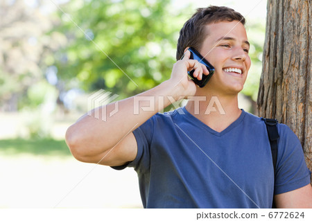 Close-up of a muscled student on the phone Close-up of a muscled student on the phone 6772624