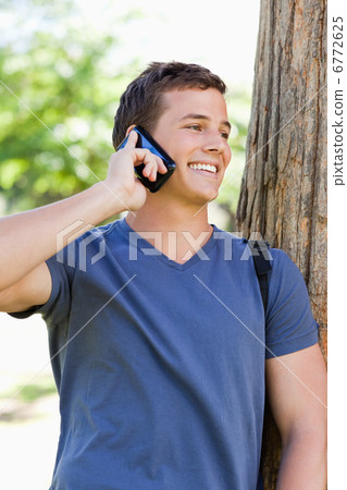 Close-up of a smiling young man on the phone Close-up of a smiling young man on the phone 6772625