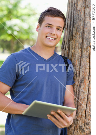 Close-up of a student using a touch pad Close-up of a student using a touch pad 6773160