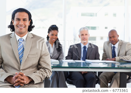 Businessman smiling while sitting with her hands crossed 6773361