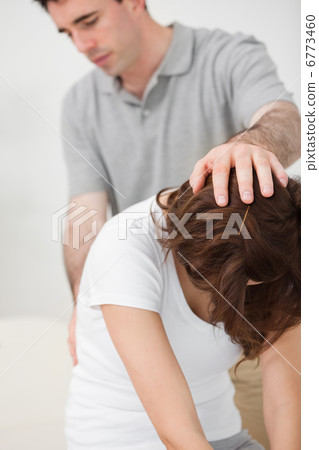 Doctor examining the back of a patient Doctor examining the back of a patient 6773460