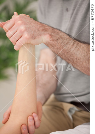 Ankle and elbow of a patient being manipulated Ankle and elbow of a patient being manipulated 6773479
