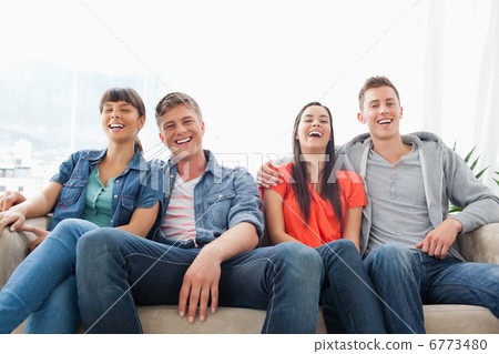 A group of laughing friends look into the camera A group of laughing friends look into the camera 6773480