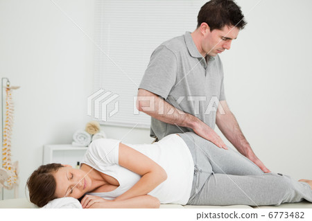 Doctor looking at the thigh of his patient 6773482