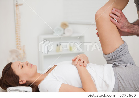 Peaceful patient being stretched by a doctor Peaceful patient being stretched by a doctor 6773600