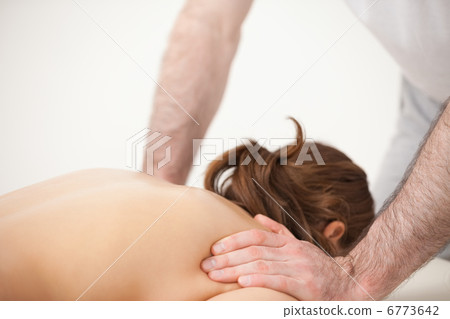 Doctor massaging the shoulders of woman while standing Doctor massaging the shoulders of woman while standing 6773642