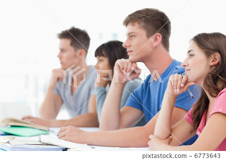Side view of four students with hands on their chins thinking Side view of four students with hands on their chins thinking 6773643