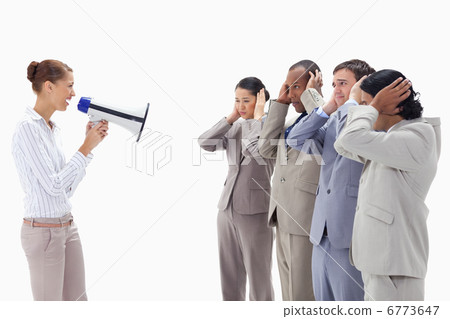 Woman yelling happily at business people covering their ears wit 6773647