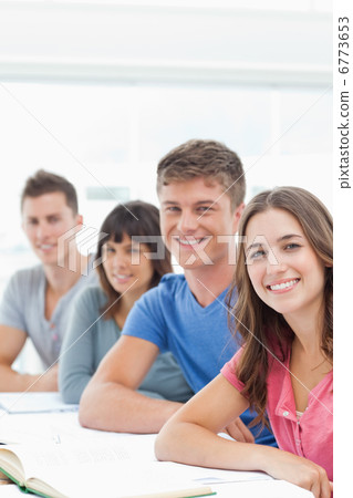 A group looking in front of them into the camera as they smile A group looking in front of them into the camera as they smile 6773653