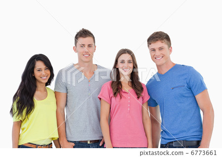 Four people standing beside one another and smiling 6773661