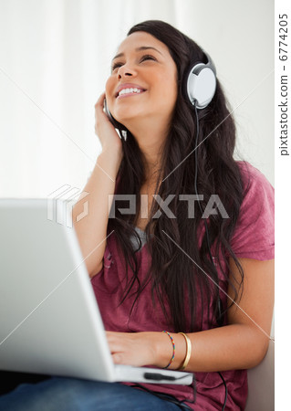 Close-up of a happy Latino student enjoying music Close-up of a happy Latino student enjoying music 6774205