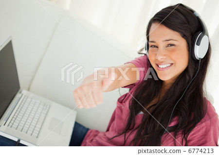 High-angle view of a student with a laptop the thumb-up High-angle view of a student with a laptop the thumb-up 6774213