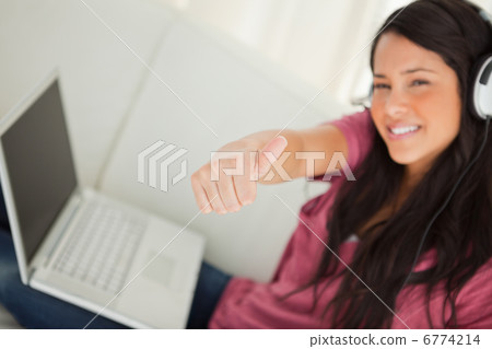 Thumb-up of a student with a laptop Thumb-up of a student with a laptop 6774214