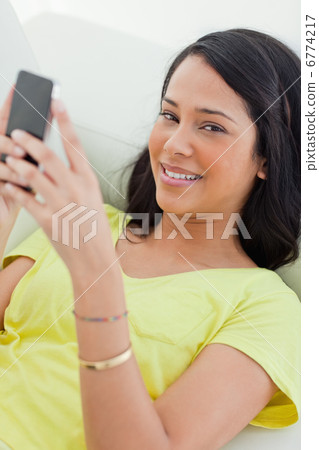 Portrait of a Latino holding her smartphone Portrait of a Latino holding her smartphone 6774217