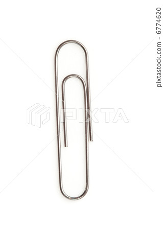 Close up of a grey paperclip on the floor 6774620