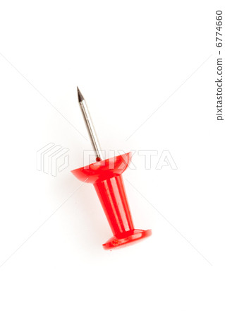 Close up of a red pushpin on the floor Close up of a red pushpin on the floor 6774660