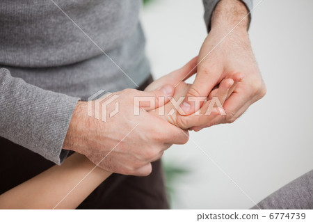 Physiotherapist massaging a hand Physiotherapist massaging a hand 6774739