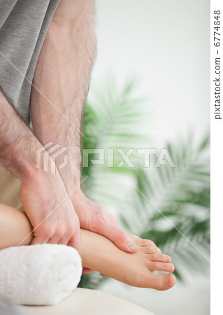 Close up of hands massaging a foot Close up of hands massaging a foot 6774848