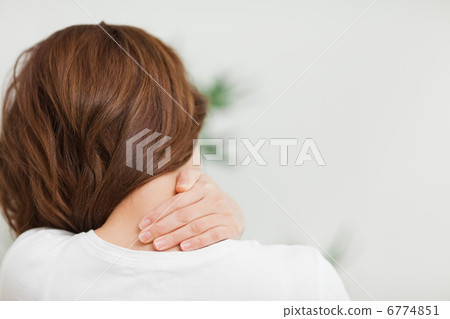 Close up of a brunette woman massing her neck 6774851