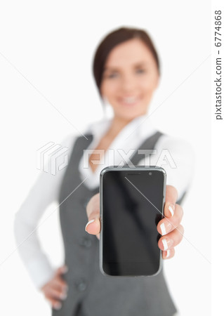 Brunette businesswoman showing her smartphone screen Brunette businesswoman showing her smartphone screen 6774868