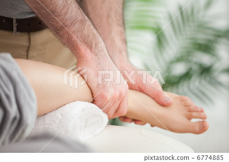 Close-up of a foot being massaged by a doctor Close-up of a foot being massaged by a doctor 6774885