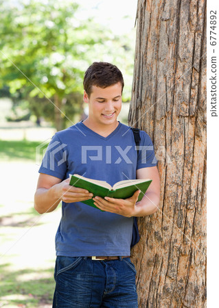 Muscled young man reading a book Muscled young man reading a book 6774892