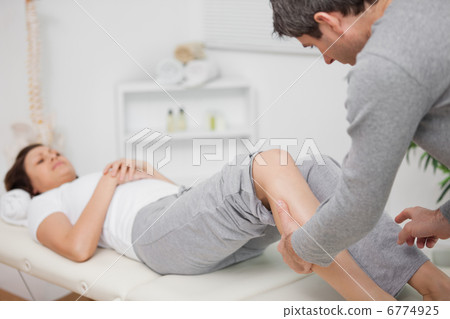 Physiotherapist massaging a calf Physiotherapist massaging a calf 6774925