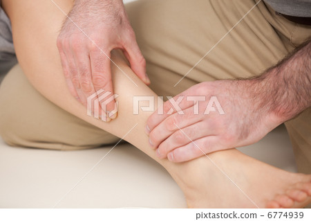 Physiotherapist massaging the shin bone Physiotherapist massaging the shin bone 6774939