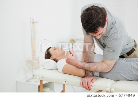 Physiotherapist massaging the pelvis of a woman 6774949