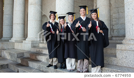 Five happy graduates posing the thumb-up 6774950
