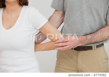 Close-up of a doctor examining the arm of a patient Close-up of a doctor examining the arm of a patient 6774982