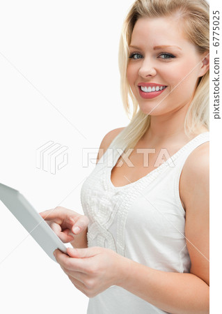 Cheerful blonde woman touching her tablet computer Cheerful blonde woman touching her tablet computer 6775025