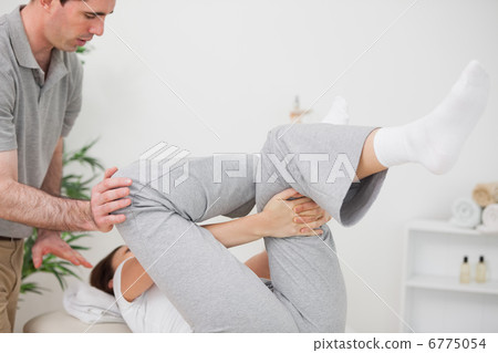 Woman doing her exercise while being helped Woman doing her exercise while being helped 6775054