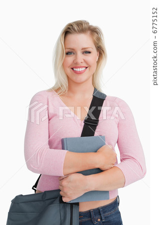 Happy blonde woman holding a school book Happy blonde woman holding a school book 6775152