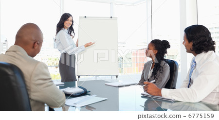Three earnest employees attentively listening to a presentation Three earnest employees attentively listening to a presentation 6775159