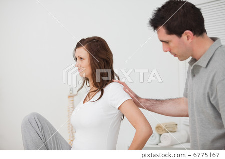 Woman sitting while a man is touching her back Woman sitting while a man is touching her back 6775167