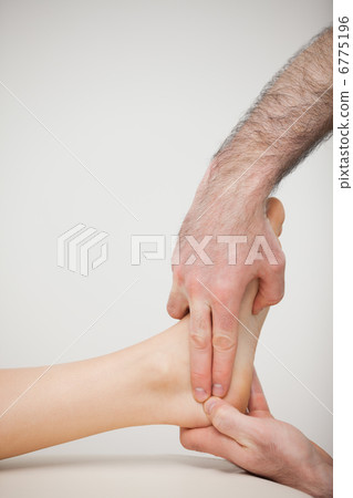 Two fingers pressing the Achilles tendon of a patient Two fingers pressing the Achilles tendon of a patient 6775196