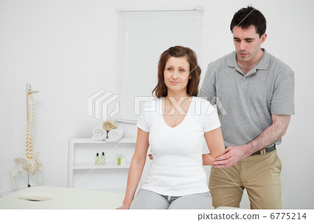 Serious practitioner holding the elbow of a patient Serious practitioner holding the elbow of a patient 6775214