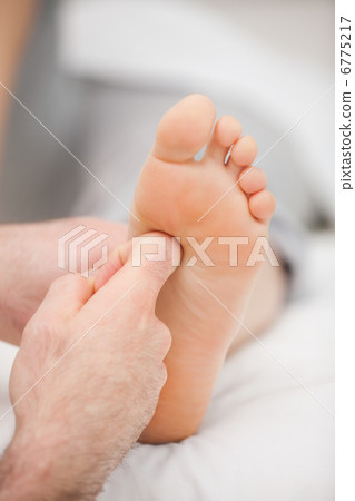 Finger massaging a foot Finger massaging a foot 6775217
