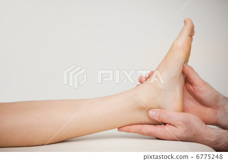 Chiropodist holding the foot of a patient 6775248