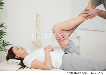 Serious brunette woman lying on a medical table Serious brunette woman lying on a medical table 6775277