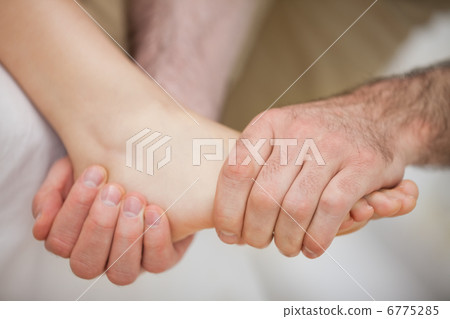 Foot being held by a practitioner 6775285