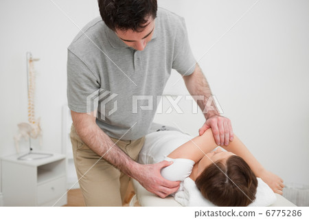 Patient lying on a medical table while being stretched 6775286
