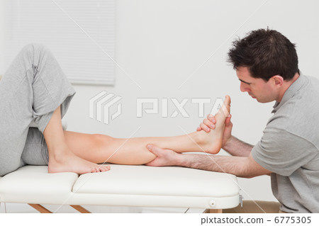 Calf of a patient being massaged by a physiotherapist Calf of a patient being massaged by a physiotherapist 6775305