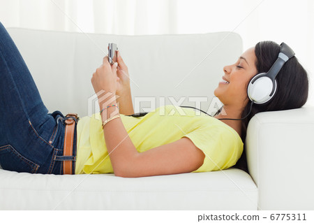 Smiling young woman watching a video Smiling young woman watching a video 6775311