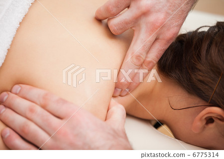 Doctor pressing the shoulder of his patient Doctor pressing the shoulder of his patient 6775314