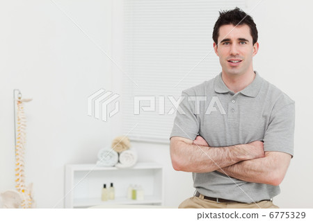 Peaceful doctor crossing his arms Peaceful doctor crossing his arms 6775329