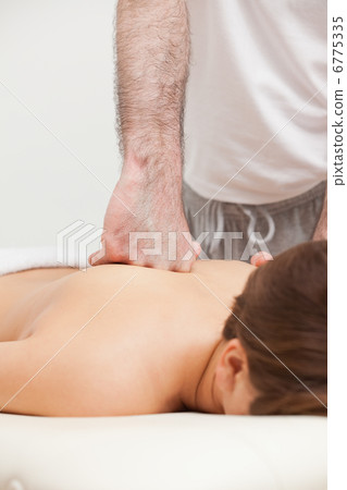 Doctor massaging his patient while using the back of his hand Doctor massaging his patient while using the back of his hand 6775335