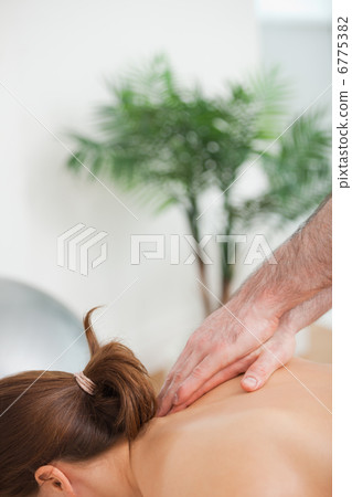 Practitioner massaging the top of back of his patient Practitioner massaging the top of back of his patient 6775382