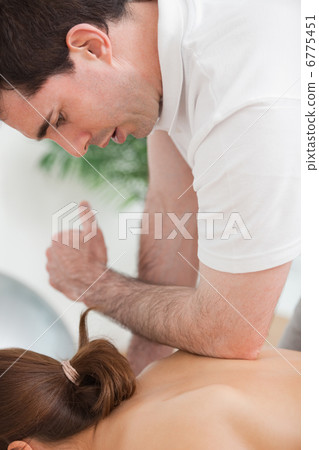 Back of woman being massaged by the elbow of doctor Back of woman being massaged by the elbow of doctor 6775451